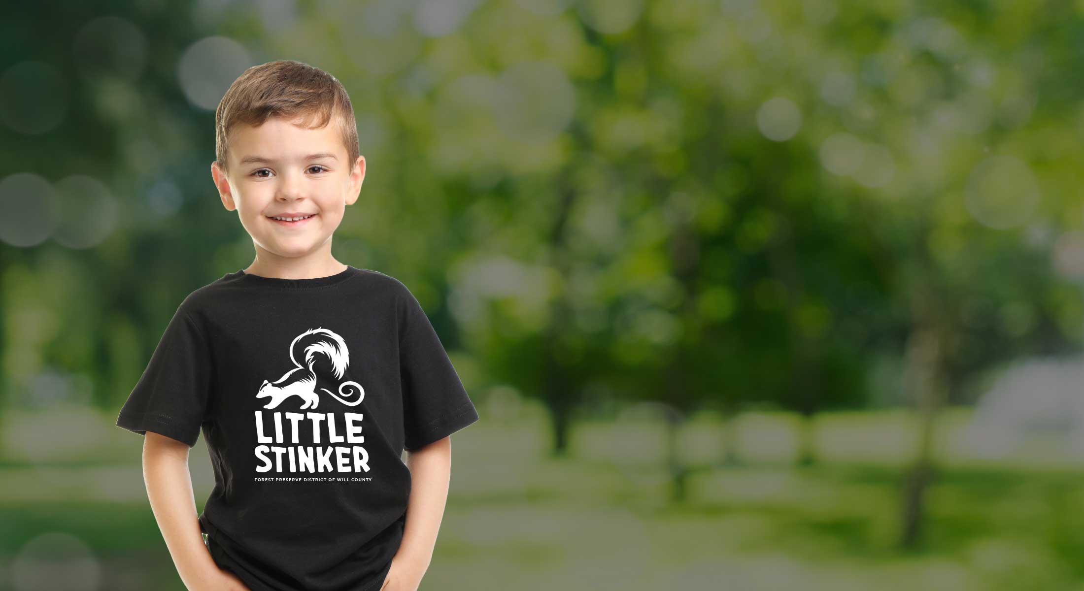 child wearing skunk shirt that says little stinker